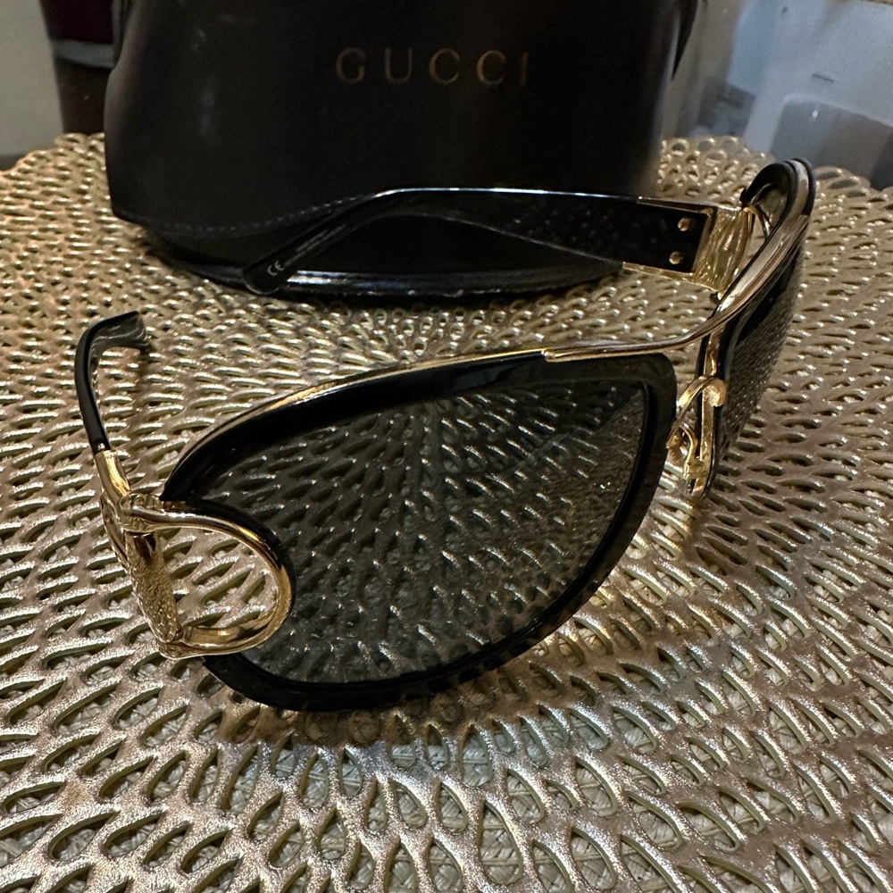 GUCCI Women’s Gorgeous sunglasses, black and gold accents.